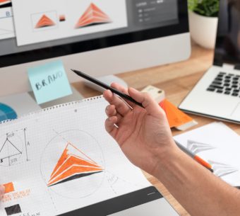 Graphic designer drawing sketches logo design. The concept of a new brand. Professional creative occupation with idea.