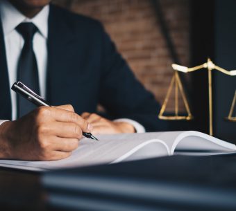 Close up lawyer businessman working or reading lawbook in office workplace for consultant lawyer concept.